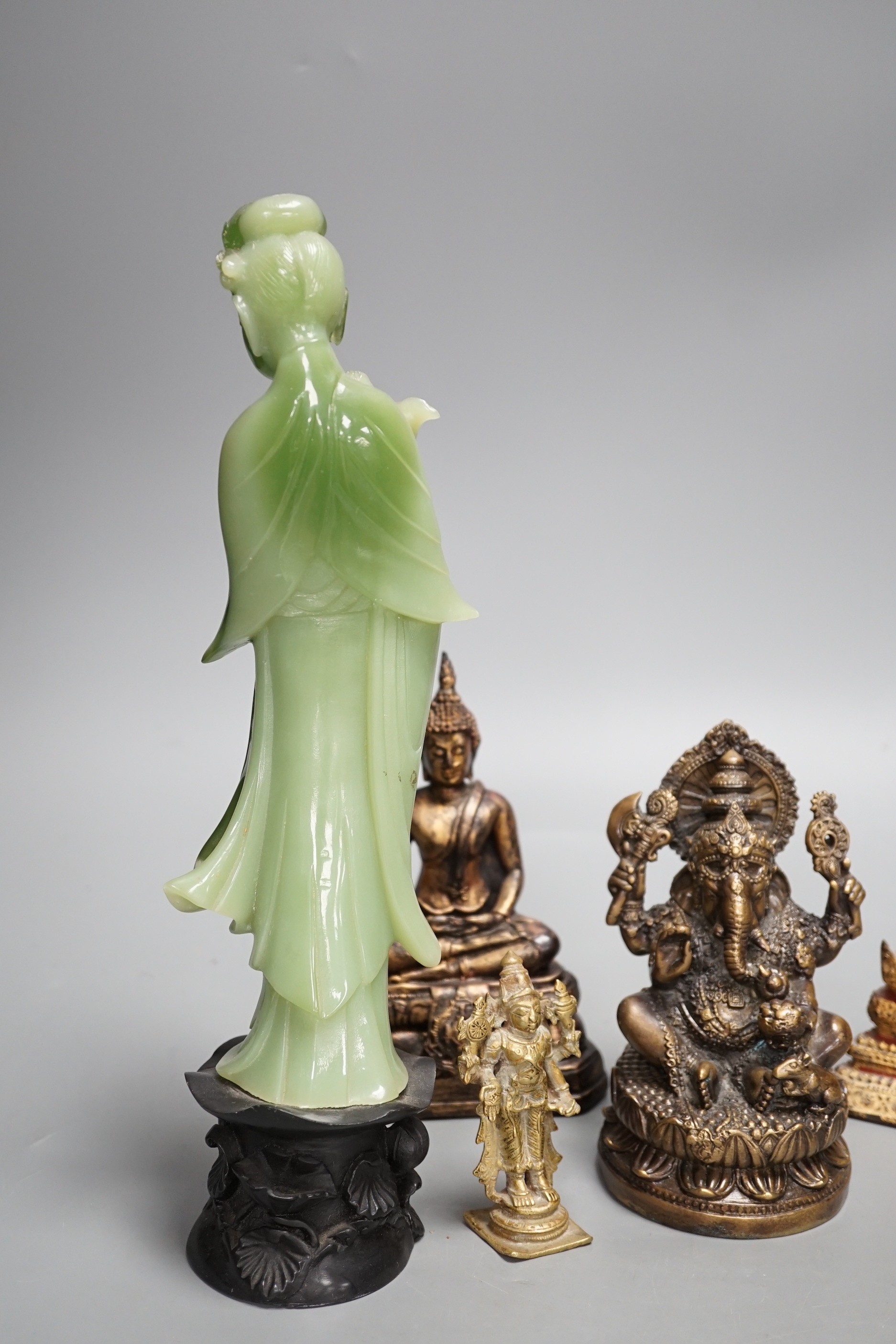 A Thai gilt resin model of Buddha, an Indian bronze model of Ganesh, a jadeite coloured carving of Guanyin and two other figures. Tallest 30cm